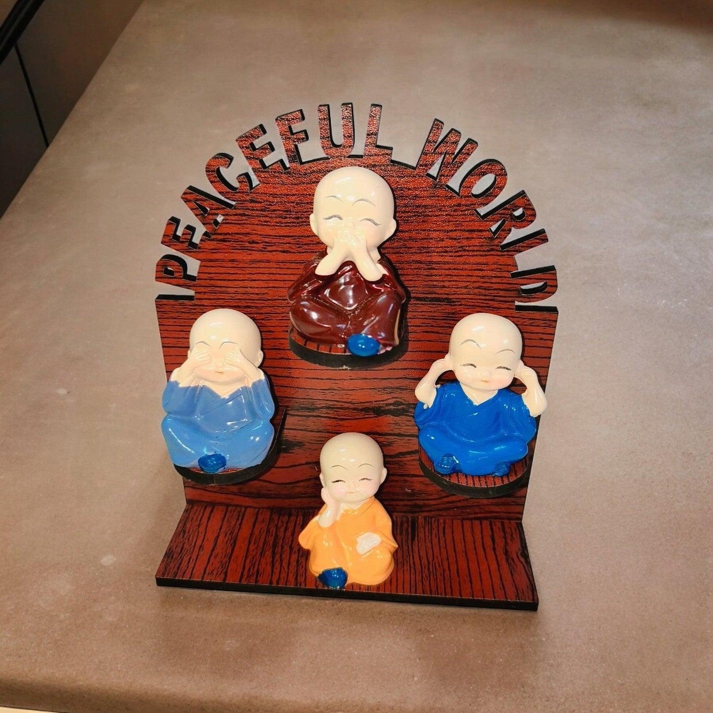 Cute Baby Monk on Wooden Base