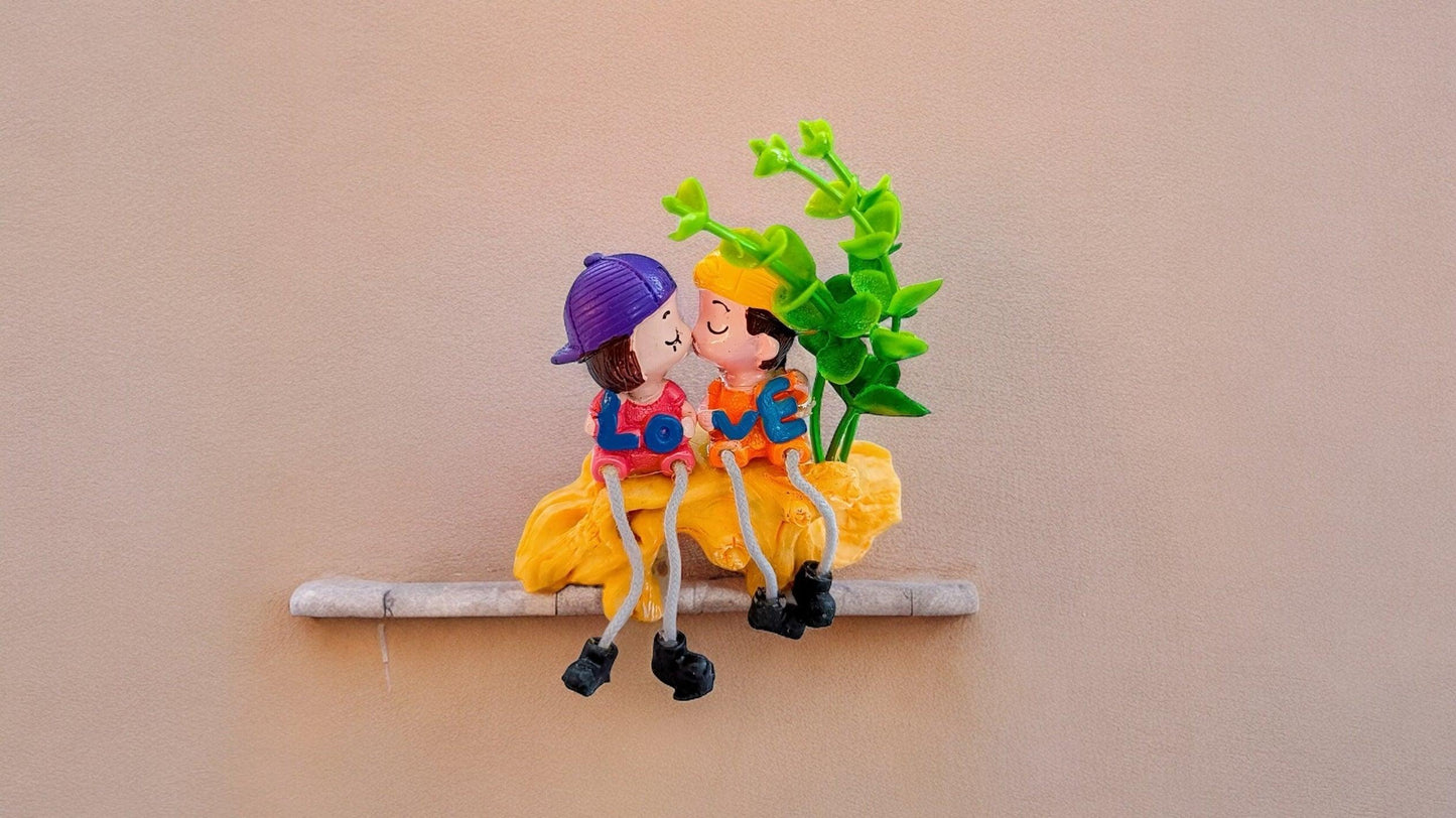 Cute Kissing Couple with Hanging Legs Sitting on the Wall
